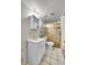 Bathroom featuring a white vanity with gold fixtures and a shower with a gold frame at 5011 Troy St, Denver, CO 80239