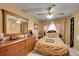 Comfortable bedroom with wood furnishings and a ceiling fan offers a relaxing retreat at 5011 Troy St, Denver, CO 80239