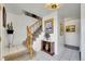 Bright entryway featuring tile flooring, stairs, and decorative accents at 5011 Troy St, Denver, CO 80239