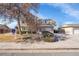 Suburban home featuring detached garage and well maintained landscaping at 5011 Troy St, Denver, CO 80239