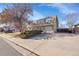 Suburban home featuring a long driveway and well maintained landscaping at 5011 Troy St, Denver, CO 80239