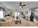 Large living room featuring a sofa, ceiling fan, and doorway leading to another space at 5011 Troy St, Denver, CO 80239
