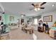 Spacious living room featuring dual ceiling fans, plush couches, and lots of natural light at 5011 Troy St, Denver, CO 80239
