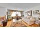 A cozy living room featuring a white sofa and decorative window treatments at 5011 Troy St, Denver, CO 80239