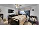 Cozy bedroom featuring a comfortable bed, ceiling fan, and entertainment center, perfect for relaxation at 5011 Troy St, Denver, CO 80239
