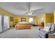 Bright main bedroom featuring yellow walls, french doors, and neutral carpet at 5011 Troy St, Denver, CO 80239