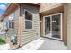 Exterior view of a back patio with siding and a sliding glass door at 9757 Ash Ln, Thornton, CO 80229