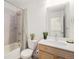 Cozy bathroom featuring a shower-tub combo and a warm vanity at 9757 Ash Ln, Thornton, CO 80229