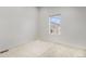 Neutral bedroom with a view to the neighborhood and ample lighting at 9757 Ash Ln, Thornton, CO 80229