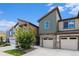 Townhome exterior featuring a stone base, neutral siding, and a well-kept lawn under a clear blue sky at 9757 Ash Ln, Thornton, CO 80229