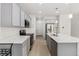 Modern kitchen with stainless steel appliances, quartz countertops, and stylish gray cabinets at 9757 Ash Ln, Thornton, CO 80229