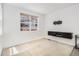 Bright living room with a large window and modern wall-mounted entertainment center at 9757 Ash Ln, Thornton, CO 80229