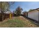 Expansive backyard with grass, a brick area, and privacy fencing at 6013 W 62Nd Ave, Arvada, CO 80033
