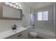 Bright bathroom featuring vanity, mirror, toilet, and tub with a window at 6013 W 62Nd Ave, Arvada, CO 80033