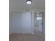 Bedroom features a closet with sliding doors and an open door leading to another room at 6013 W 62Nd Ave, Arvada, CO 80033