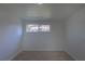 Cozy bedroom with neutral walls, carpet, and a window providing natural light at 6013 W 62Nd Ave, Arvada, CO 80033