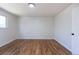 Bedroom featuring hardwood floors and a door to the hallway at 6013 W 62Nd Ave, Arvada, CO 80033