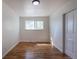 Bedroom featuring hardwood floors, closet, and a bright window at 6013 W 62Nd Ave, Arvada, CO 80033