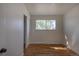 Bright bedroom featuring hardwood floors, a window, and white painted walls at 6013 W 62Nd Ave, Arvada, CO 80033