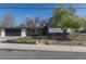 Charming home features brick accents, mature trees, an attached garage, and well-maintained landscaping at 6013 W 62Nd Ave, Arvada, CO 80033