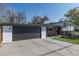 Charming two-story home with a well-maintained lawn, a large driveway, and mature trees enhancing the curb appeal at 6013 W 62Nd Ave, Arvada, CO 80033
