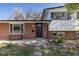 Inviting home exterior with a brick facade, front bench, green lawn, and easy access at 6013 W 62Nd Ave, Arvada, CO 80033