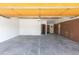 Spacious garage with concrete floor, white walls and wooden ceiling, offering ample parking and storage space at 6013 W 62Nd Ave, Arvada, CO 80033