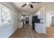 Open concept kitchen with white cabinets, black refrigerator and stainless steel appliances at 6013 W 62Nd Ave, Arvada, CO 80033