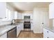 Bright and updated kitchen features stainless steel appliances, stone countertops, and modern fixtures at 6013 W 62Nd Ave, Arvada, CO 80033