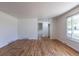 Large living area showcasing hardwood flooring, a window, and closet for storage at 6013 W 62Nd Ave, Arvada, CO 80033