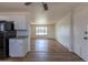 Open floor plan with wood-look flooring connecting the living room to the updated kitchen at 6013 W 62Nd Ave, Arvada, CO 80033