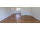 Open living room features hardwood floors, neutral paint, and a ceiling fan at 6013 W 62Nd Ave, Arvada, CO 80033