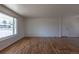 Spacious living room boasts hardwood floors and a large window providing natural light at 6013 W 62Nd Ave, Arvada, CO 80033