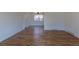 Open living room features hardwood floors, natural light, and a neutral color palette at 6013 W 62Nd Ave, Arvada, CO 80033