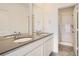 Bathroom featuring a double sink vanity with gray countertop and a shower with glass door at 8895 San Antonio St, Littleton, CO 80125