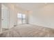 Spacious bedroom with plush carpet, a sliding glass door, and plenty of natural light at 8895 San Antonio St, Littleton, CO 80125