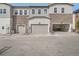 Charming townhouse exteriors featuring stone accents and attached garages for convenient parking at 8895 San Antonio St, Littleton, CO 80125