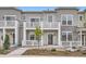 Inviting townhouse featuring a private balcony, a well-manicured lawn, and a charming, light gray exterior at 8895 San Antonio St, Littleton, CO 80125