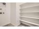 Laundry room offering convenient hookups, tile floors, and shelving for ample storage at 8895 San Antonio St, Littleton, CO 80125