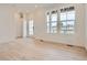 Bright living room showcasing beautiful hardwood floors and large windows that fill the space with natural light at 8895 San Antonio St, Littleton, CO 80125