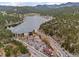 Breathtaking aerial view showcasing a lake, town, and winding roads against a mountainous landscape at 27891 Columbine Rd, Evergreen, CO 80439