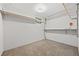 A cozy basement area featuring carpeted floors and ample shelving at 27891 Columbine Rd, Evergreen, CO 80439
