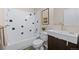 Bathroom features white tile shower with dark accents, modern vanity, and matching decorative mirror at 27891 Columbine Rd, Evergreen, CO 80439