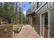 Home exterior with beautiful brick patio and lush landscape surrounding at 27891 Columbine Rd, Evergreen, CO 80439