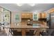 Spacious kitchen with wooden cabinets, stainless steel appliances, an eat-in island and tile backsplash at 27891 Columbine Rd, Evergreen, CO 80439