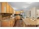Bright kitchen features granite countertops, wooden cabinets, stainless steel appliances and an eat-in island at 27891 Columbine Rd, Evergreen, CO 80439