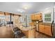 Open eat in kitchen features granite countertops, wooden cabinets, stainless steel appliances and a brick fireplace at 27891 Columbine Rd, Evergreen, CO 80439