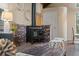 Cozy living room featuring a brick fireplace, wood ceilings, and neutral decor at 27891 Columbine Rd, Evergreen, CO 80439
