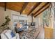 Relaxing living room featuring wood ceilings, a fireplace, and ample seating at 27891 Columbine Rd, Evergreen, CO 80439