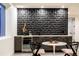 Elegant bar area with a geometric backsplash, mini fridge, and stylish seating at 3087 S Dexter Way, Denver, CO 80222